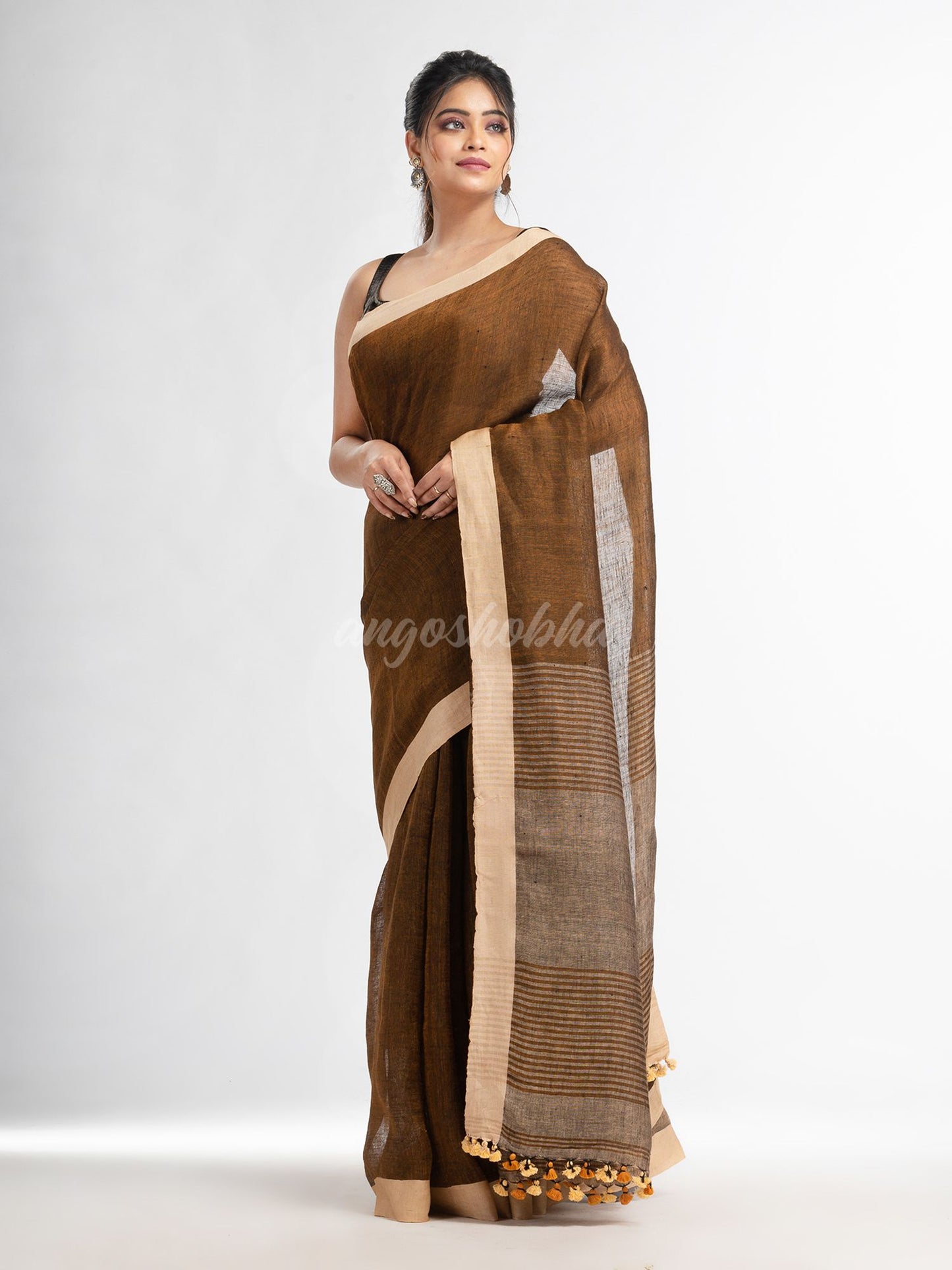 Brown with multi colour pallu in solit broder handwoven linen saree