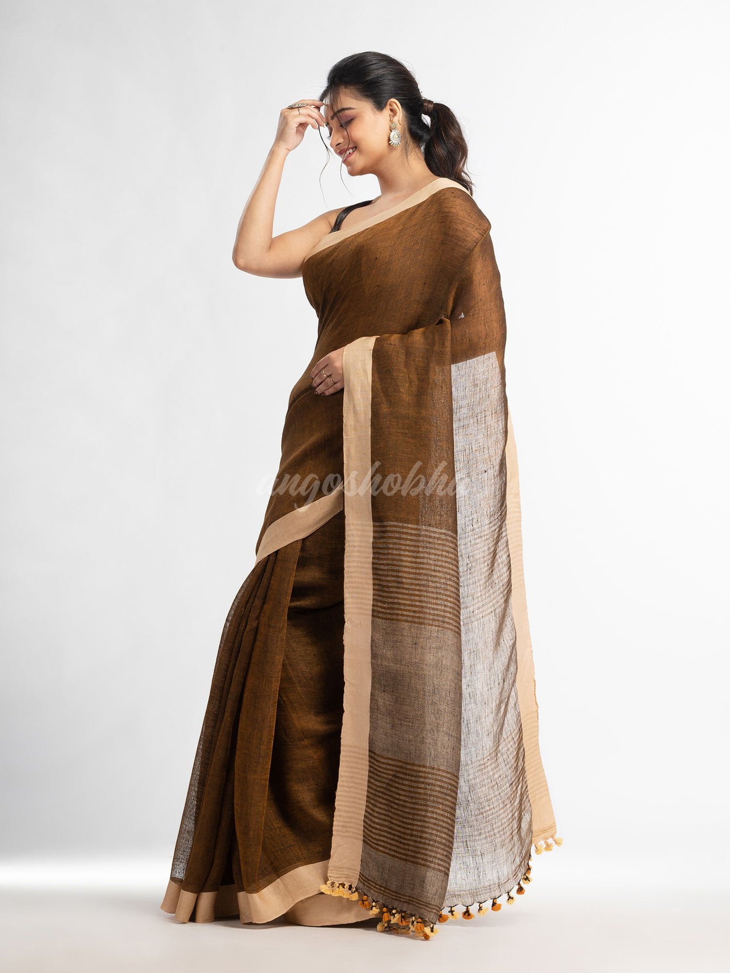 Brown with multi colour pallu in solit broder handwoven linen saree