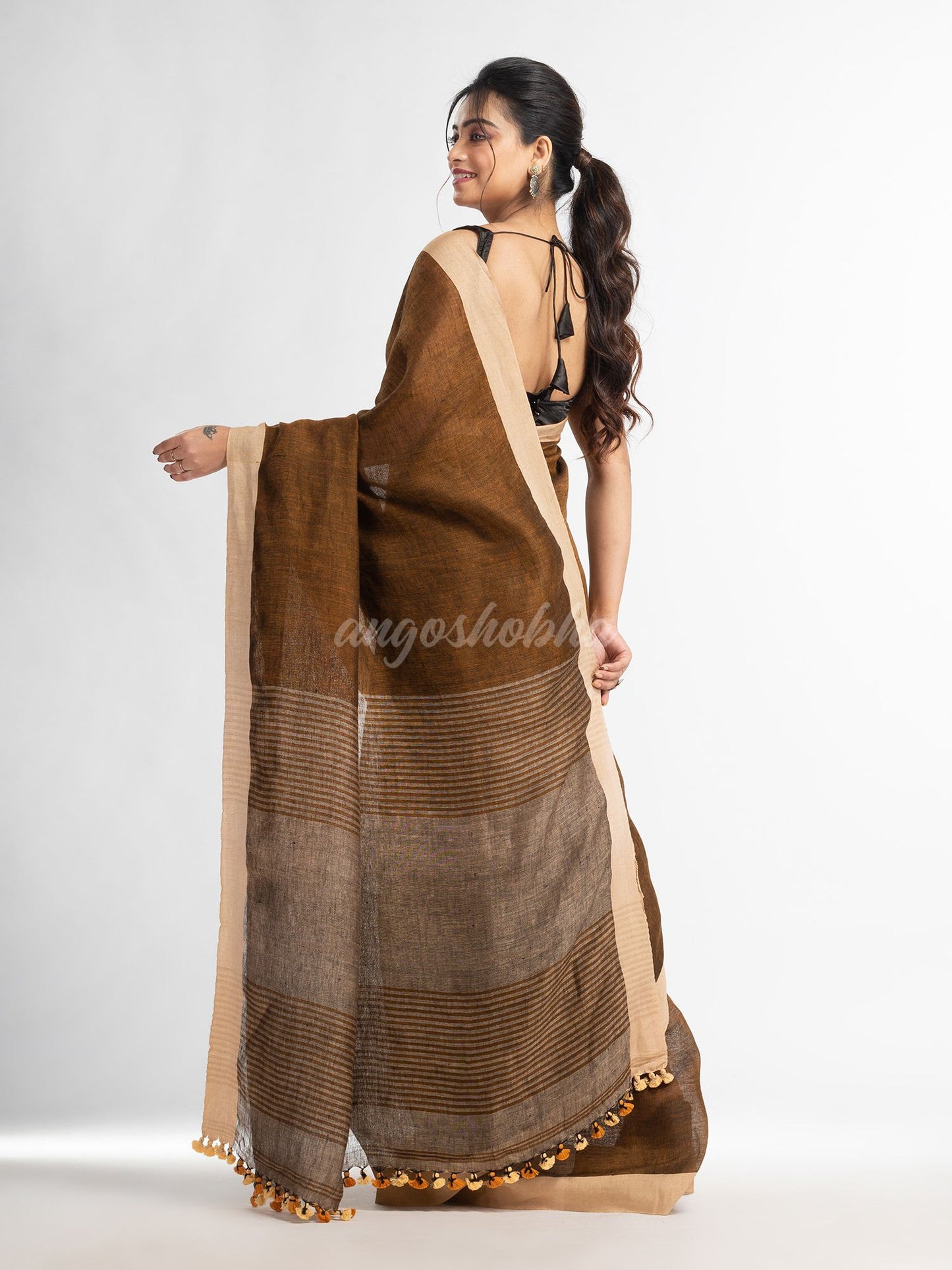 Brown with multi colour pallu in solit broder handwoven linen saree