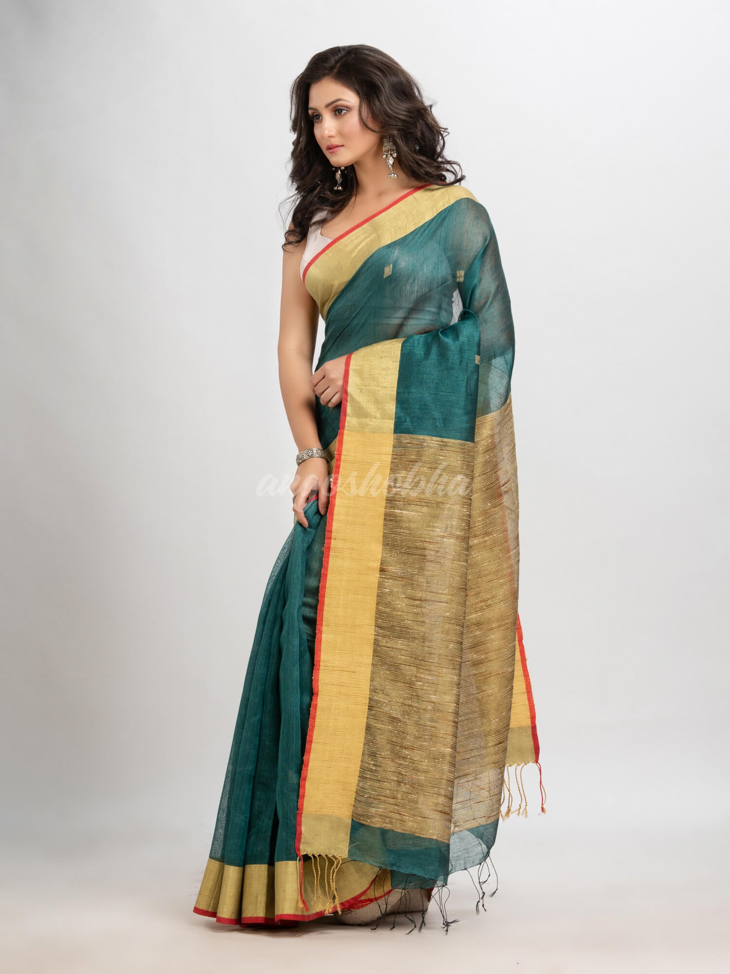 Dark teal silk blend linen with  solid border jamdani saree