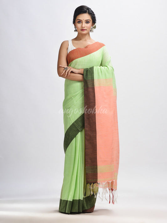 Light green cotton with solid body in tawny peach pallu handloom saree