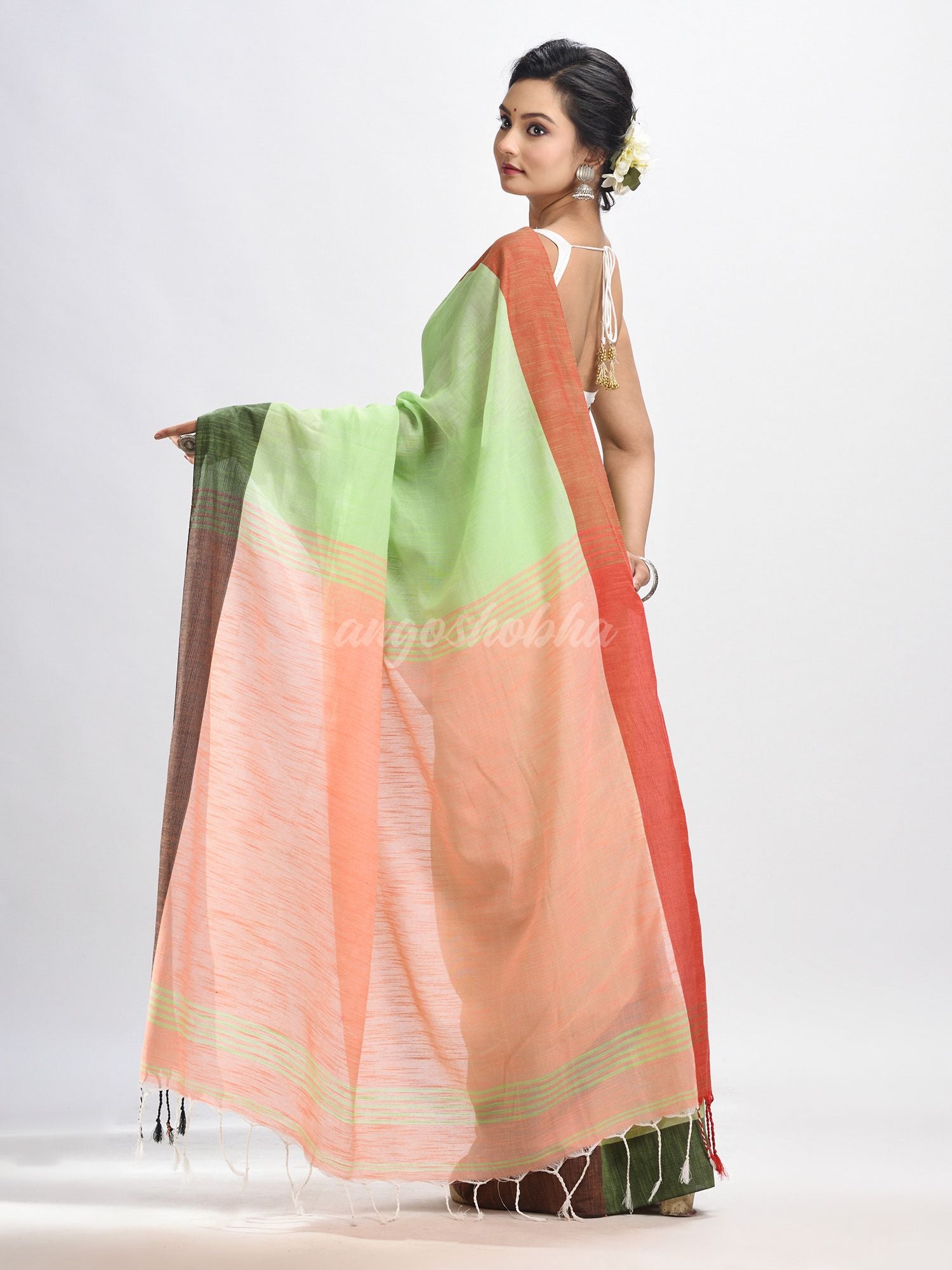 Light green cotton with solid body in tawny peach pallu handloom saree