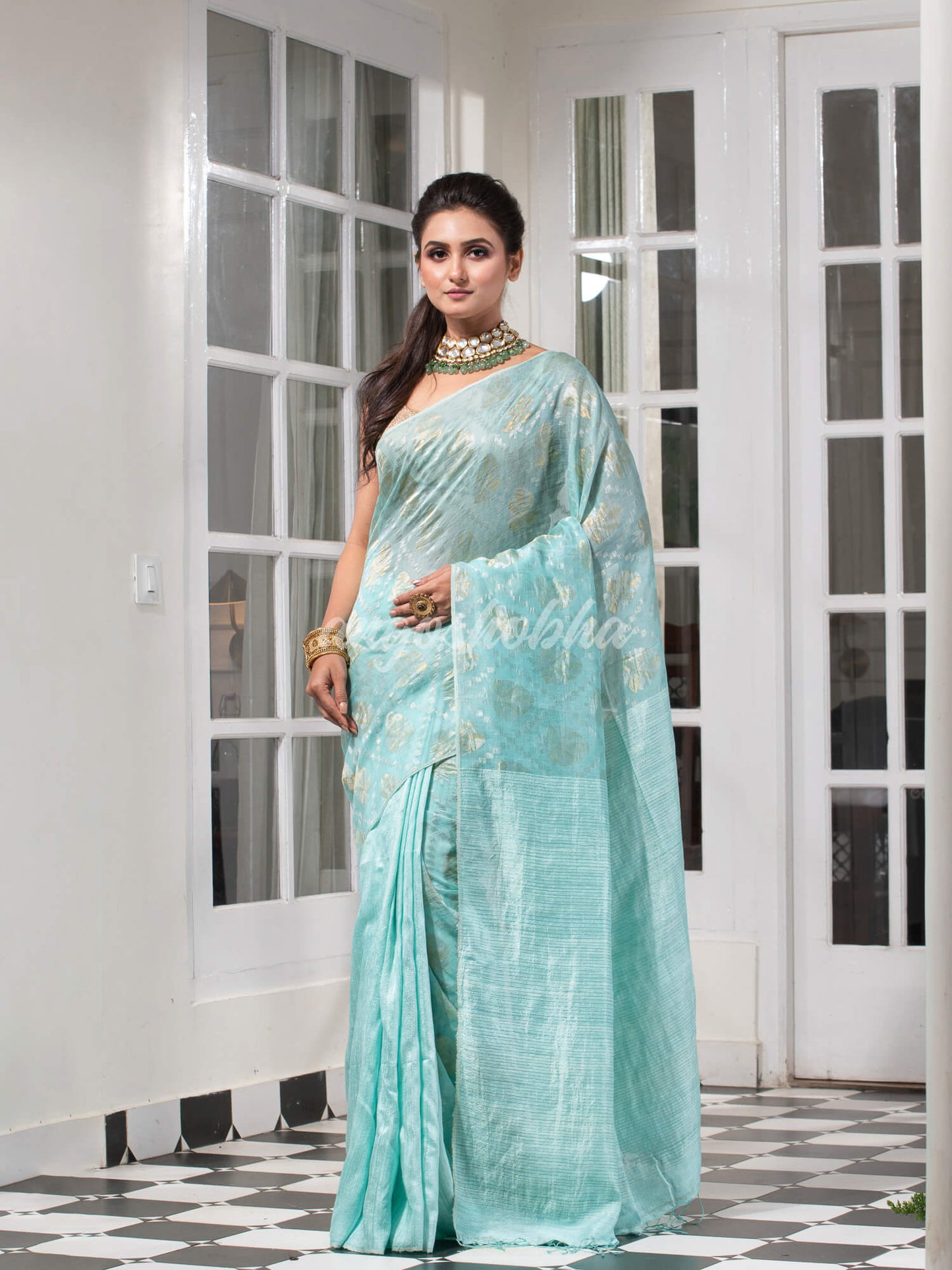 Teal Silk Matka Body with Leaves Intricate Design including Silver & Golden Stripes on Check Pallu Handwoven Saree