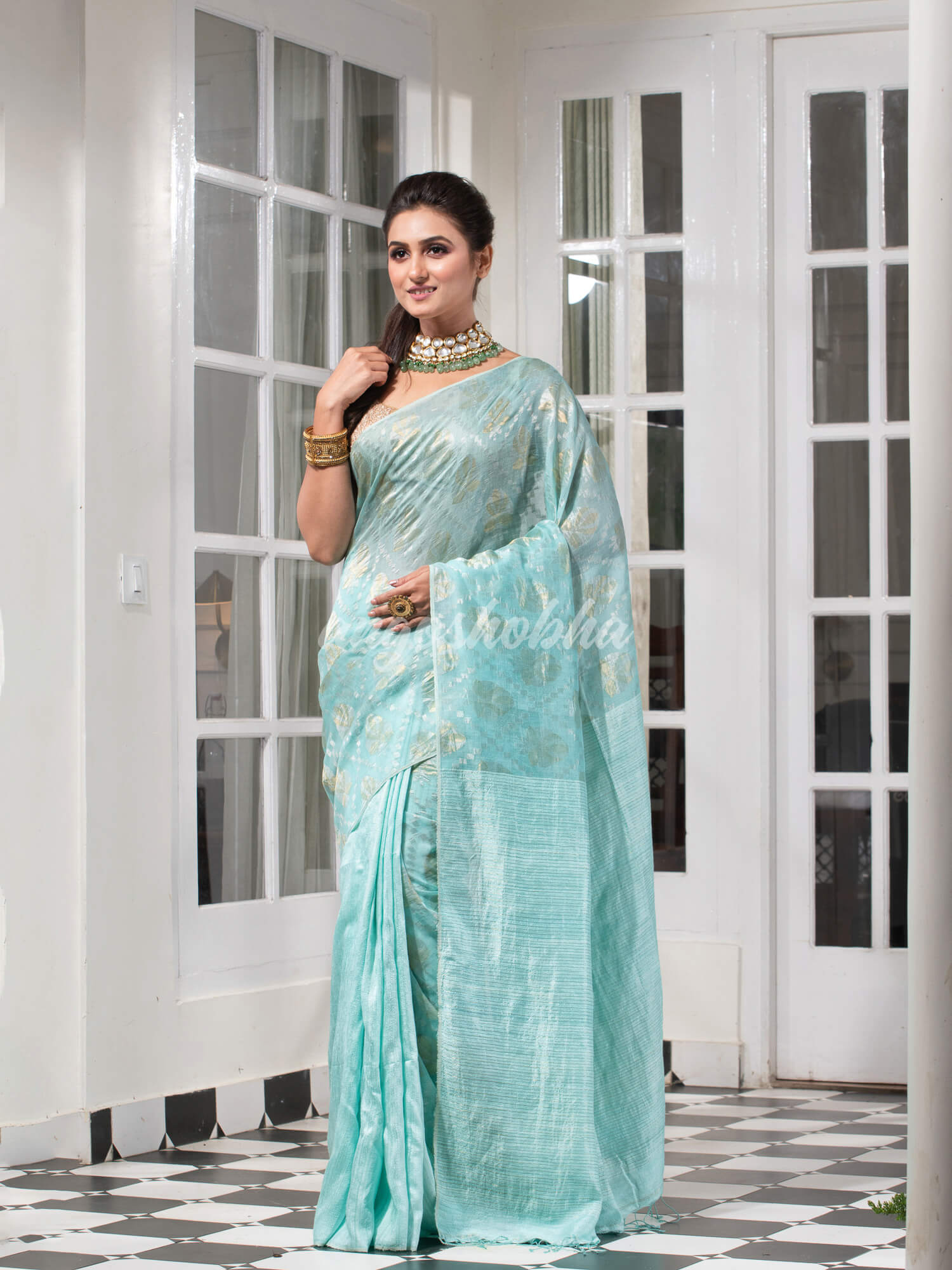 Teal Silk Matka Body with Leaves Intricate Design including Silver & Golden Stripes on Check Pallu Handwoven Saree