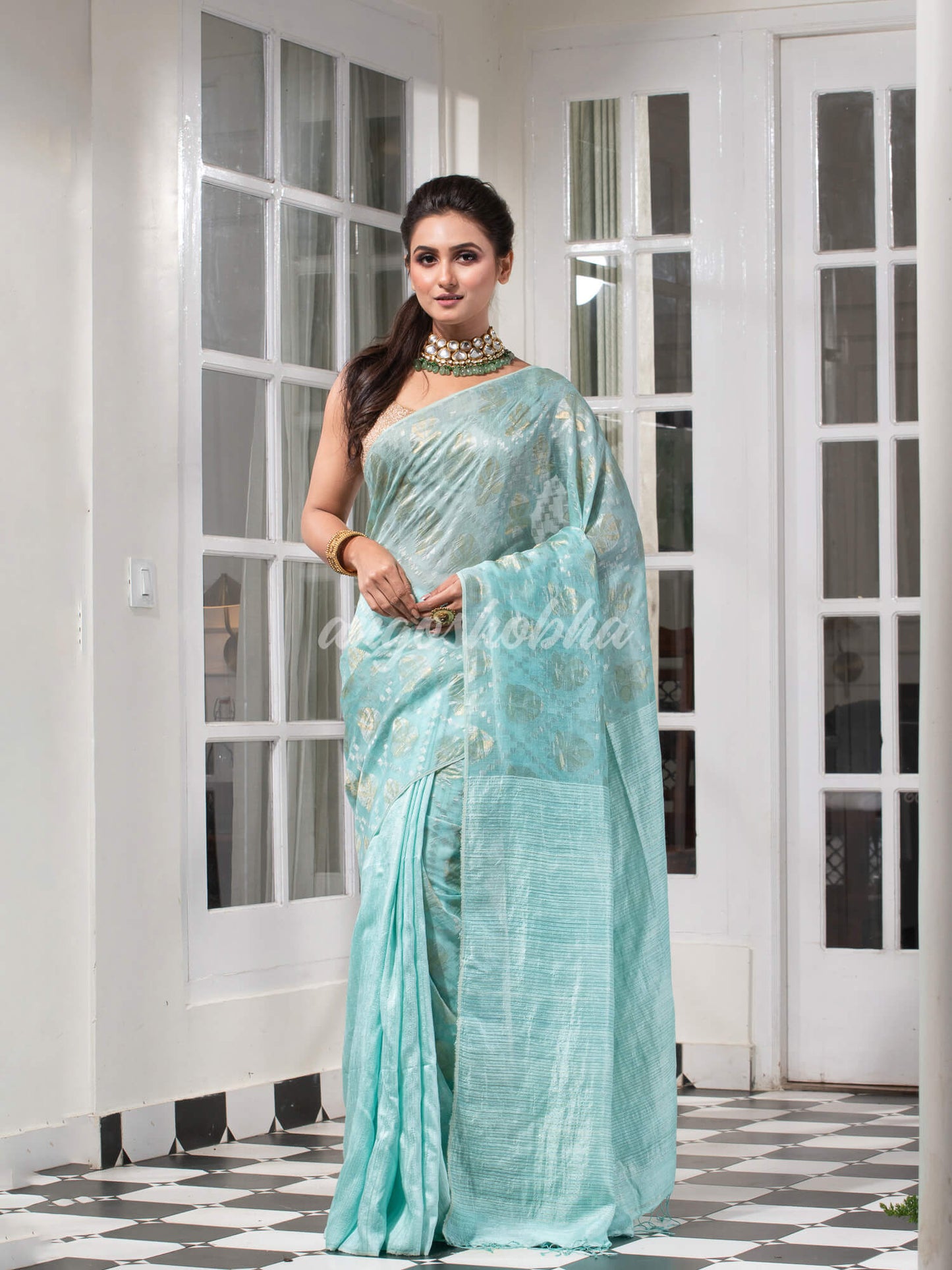 Teal Silk Matka Body with Leaves Intricate Design including Silver & Golden Stripes on Check Pallu Handwoven Saree
