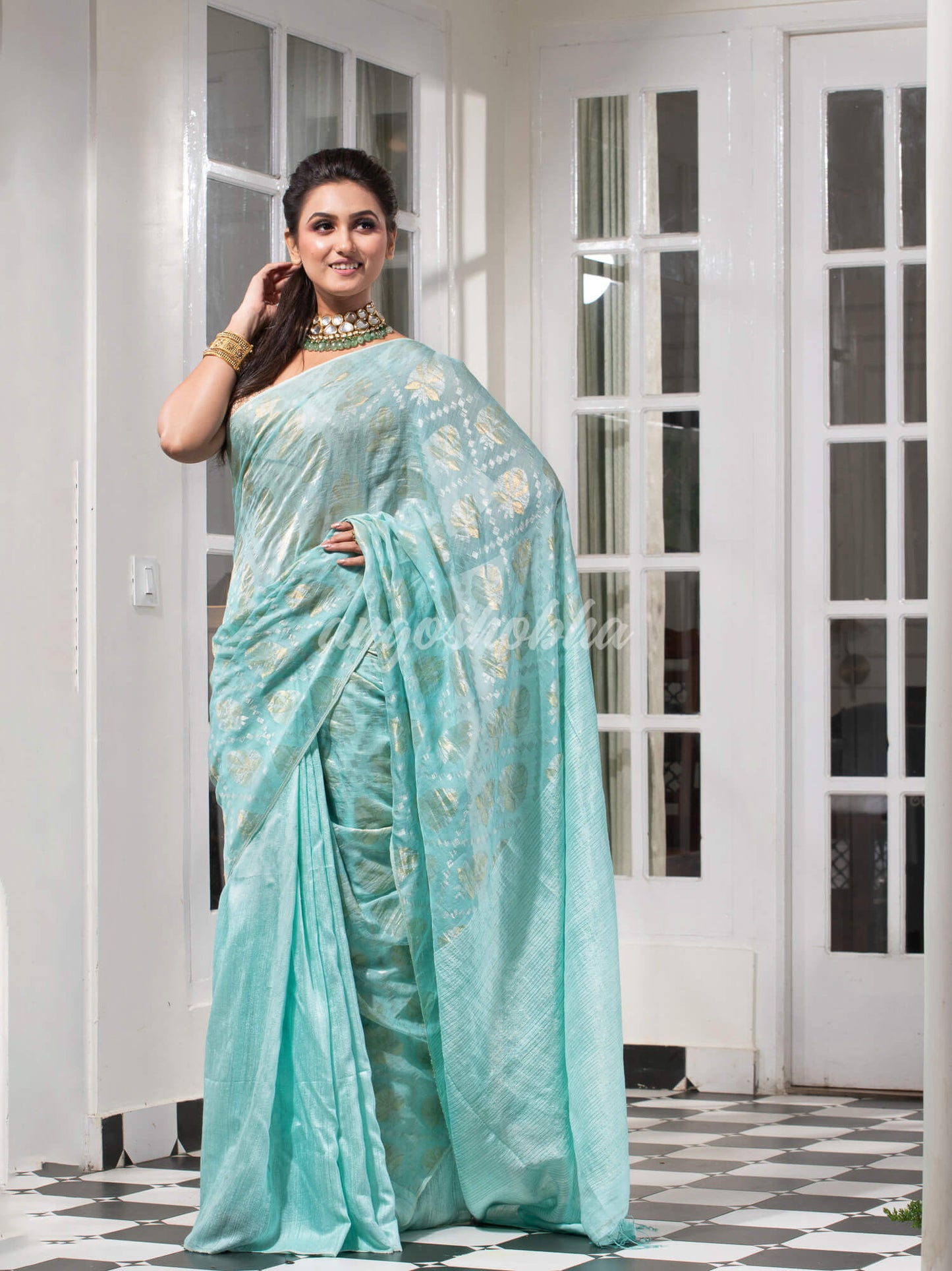 Teal Silk Matka Body with Leaves Intricate Design including Silver & Golden Stripes on Check Pallu Handwoven Saree