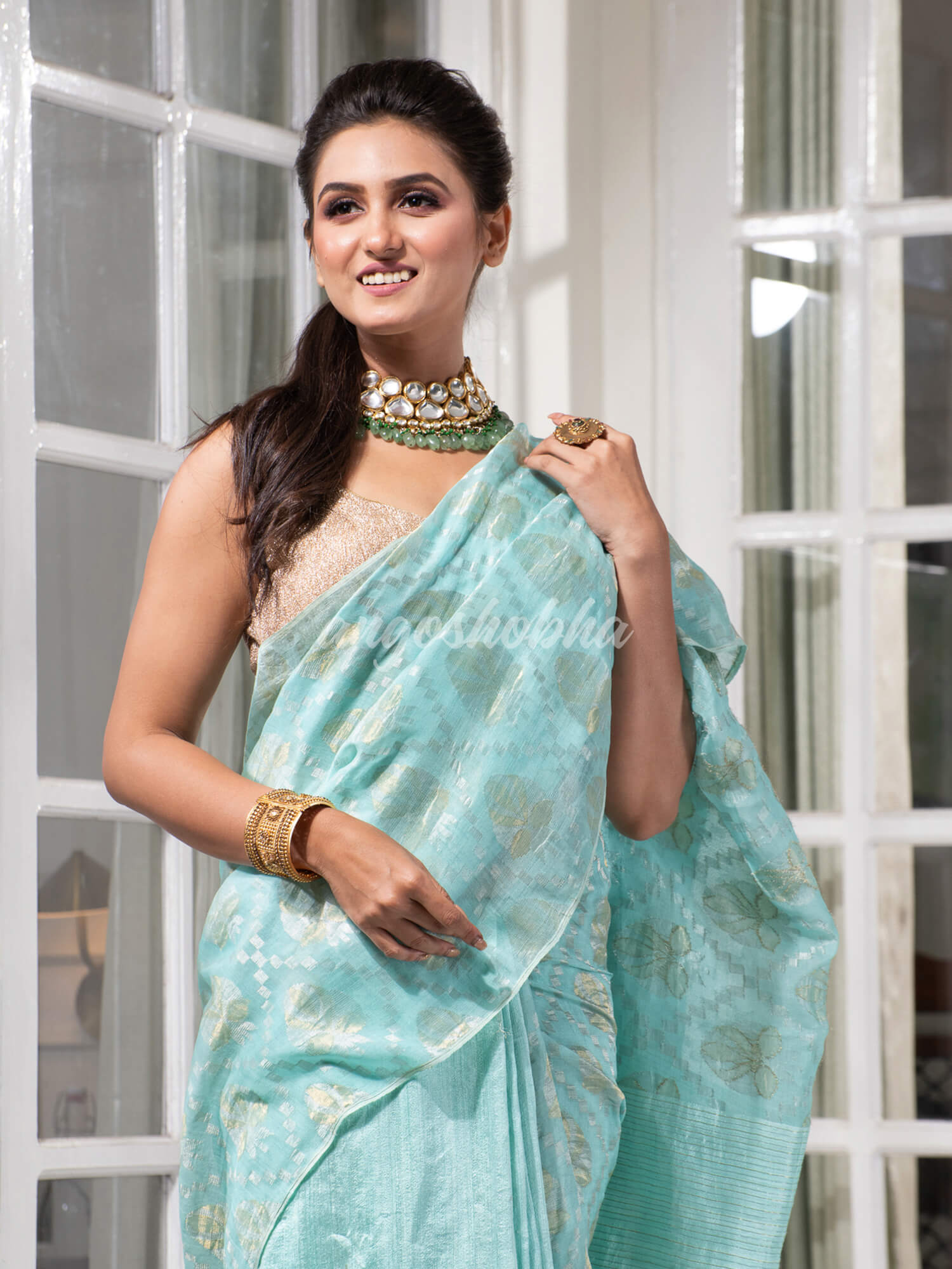 Teal Silk Matka Body with Leaves Intricate Design including Silver & Golden Stripes on Check Pallu Handwoven Saree