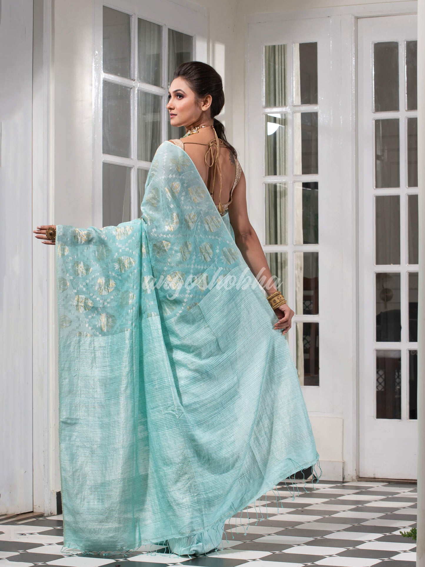 Teal Silk Matka Body with Leaves Intricate Design including Silver & Golden Stripes on Check Pallu Handwoven Saree