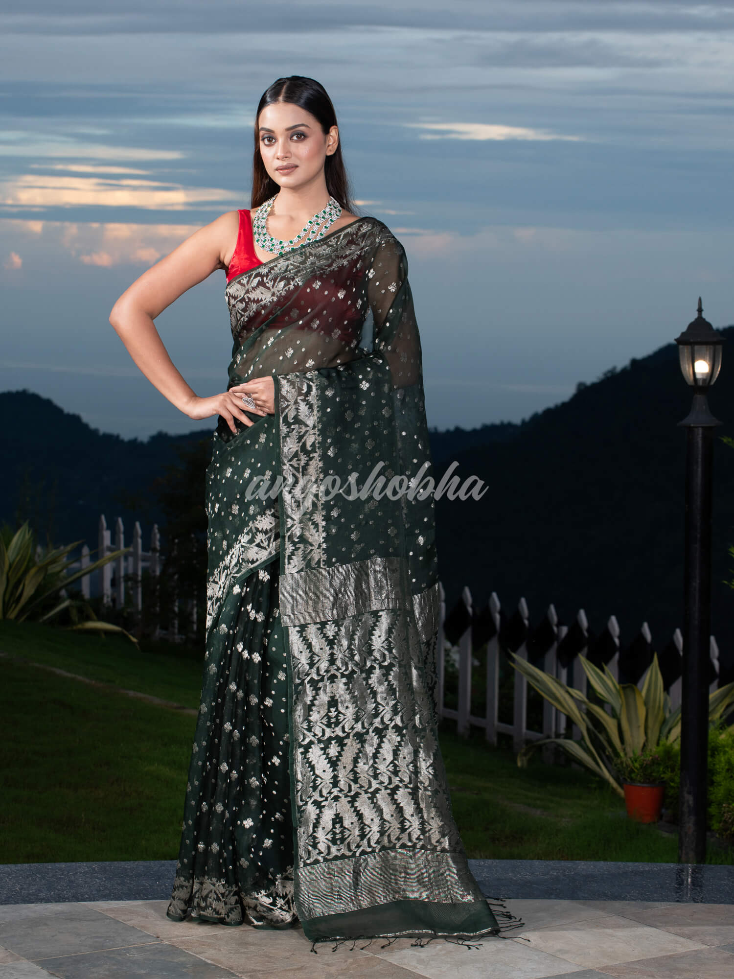 Bottle Green Silk Muslin Body and The Hem with Intricate Silver Motifs Design  Handwoven Saree