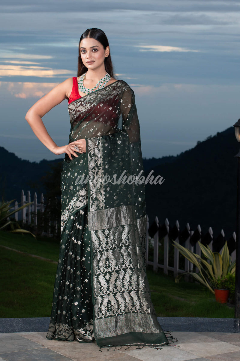 Bottle Green Silk Muslin Body and The Hem with Intricate Silver Motifs Design  Handwoven Saree