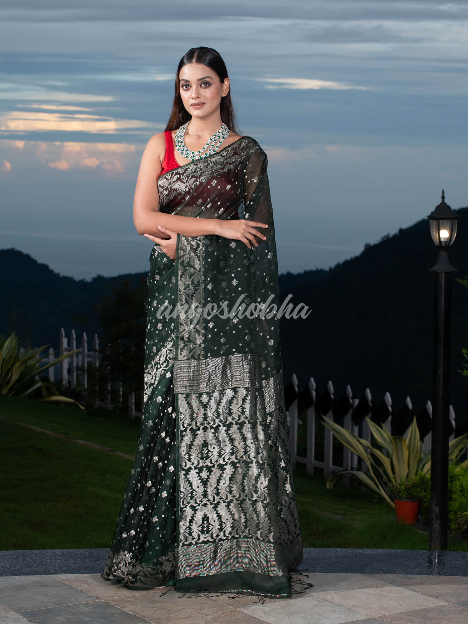 Bottle Green Silk Muslin Body and The Hem with Intricate Silver Motifs Design  Handwoven Saree