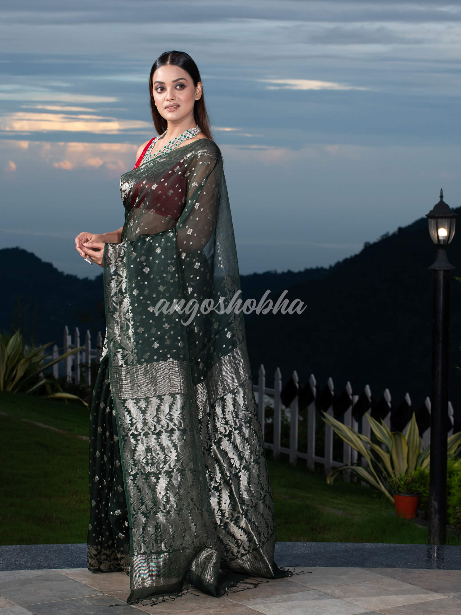 Bottle Green Silk Muslin Body and The Hem with Intricate Silver Motifs Design  Handwoven Saree