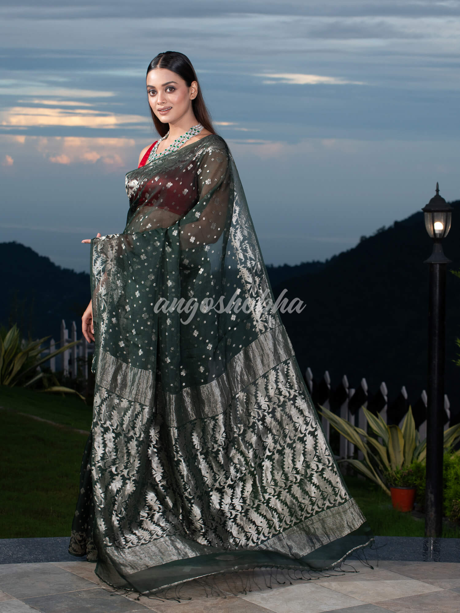 Bottle Green Silk Muslin Body and The Hem with Intricate Silver Motifs Design  Handwoven Saree