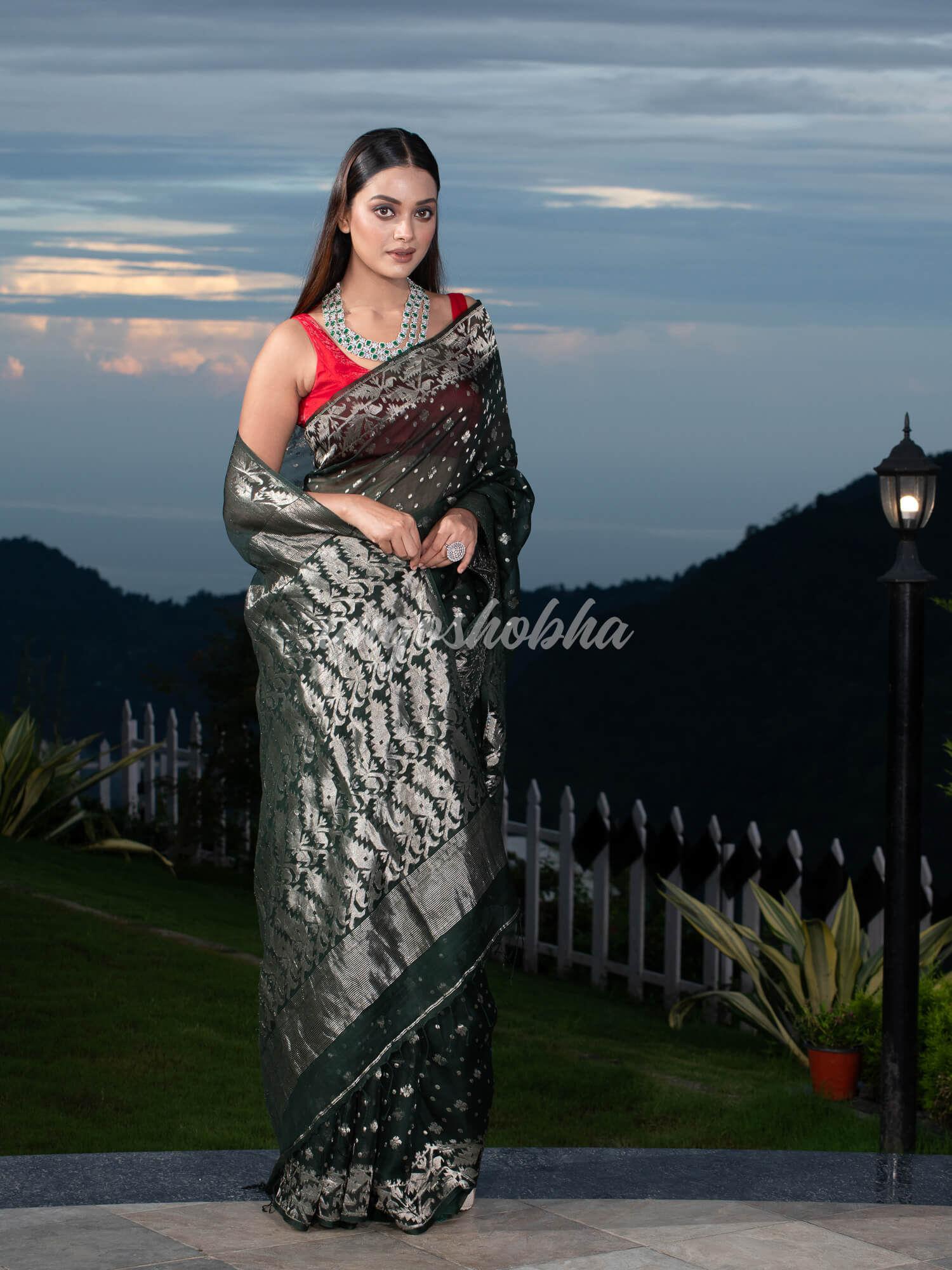Bottle Green Silk Muslin Body and The Hem with Intricate Silver Motifs Design  Handwoven Saree