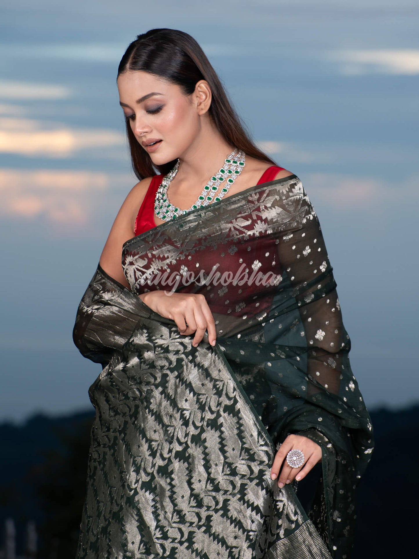 Bottle Green Silk Muslin Body and The Hem with Intricate Silver Motifs Design  Handwoven Saree