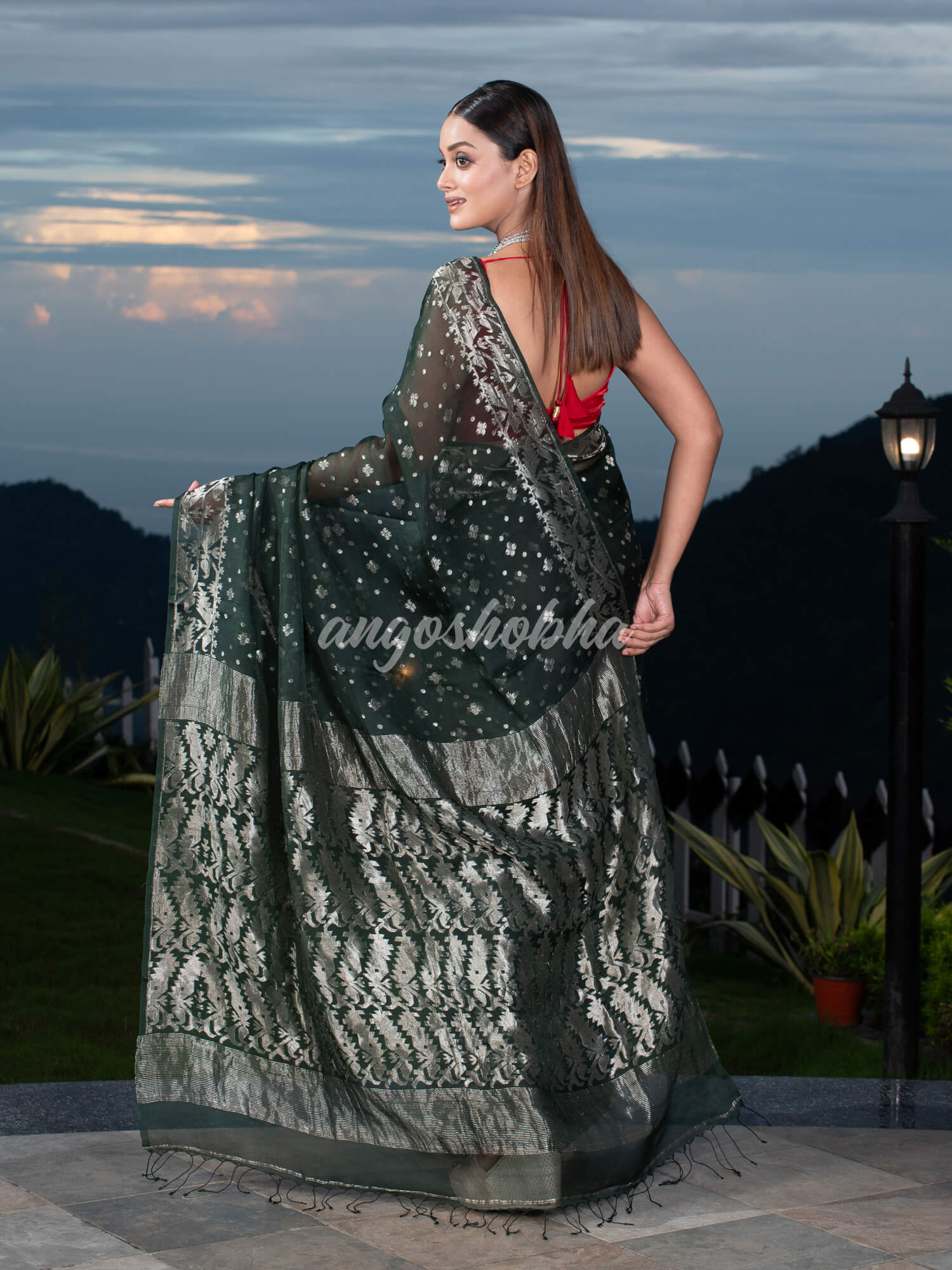 Bottle Green Silk Muslin Body and The Hem with Intricate Silver Motifs Design  Handwoven Saree